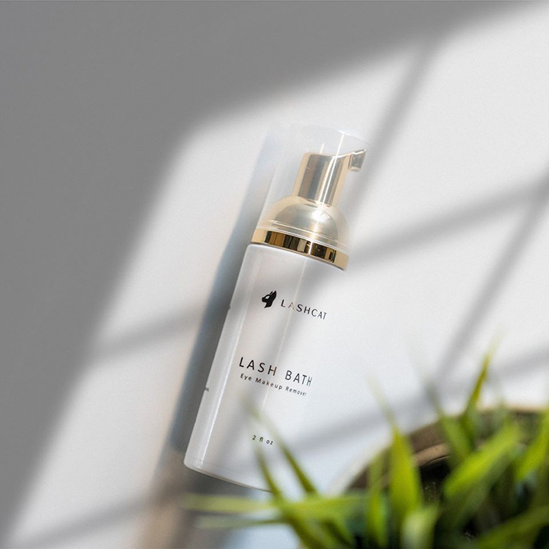 a bottle of make up is shown with the lashcat logo