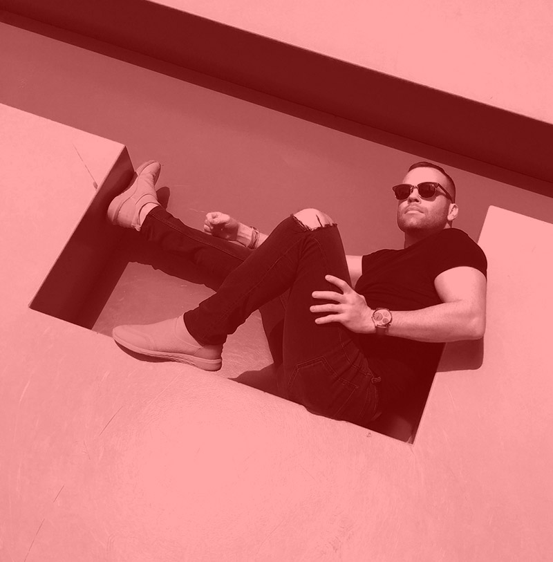 dave sits on a large sign in kingston