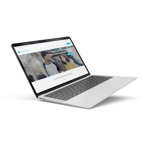 a laptop floats while displaying the youthdiversion.org non-profit website in kingston