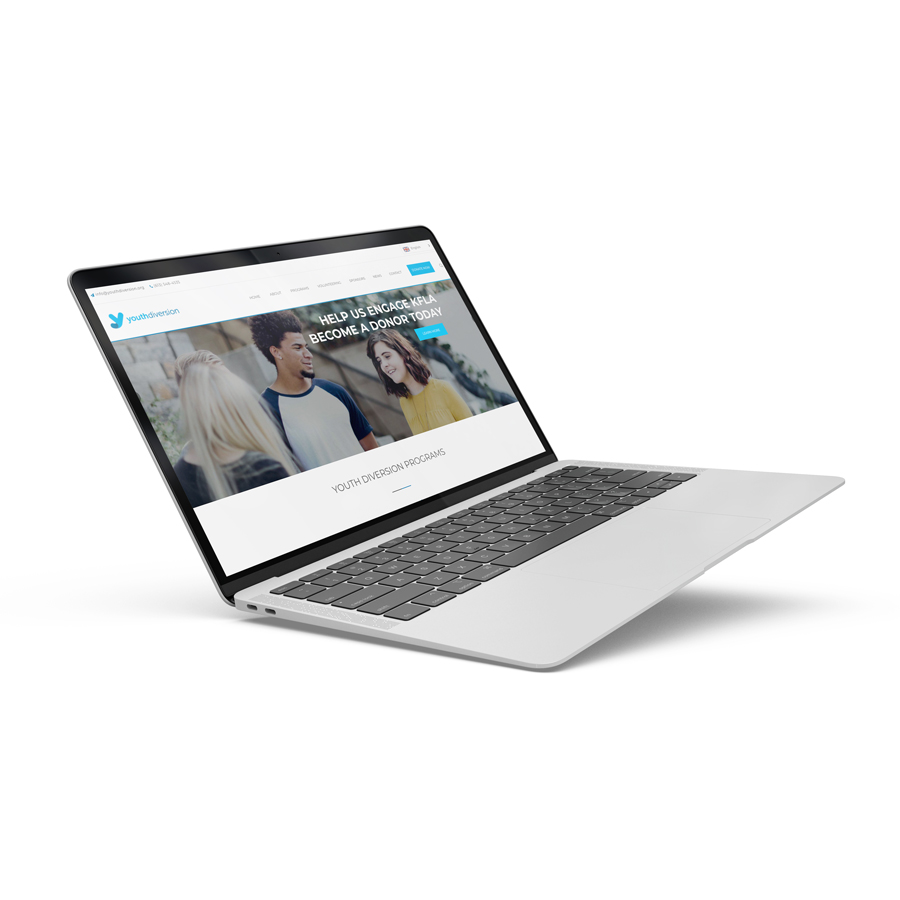 a laptop floats while displaying the youthdiversion.org non-profit website in kingston